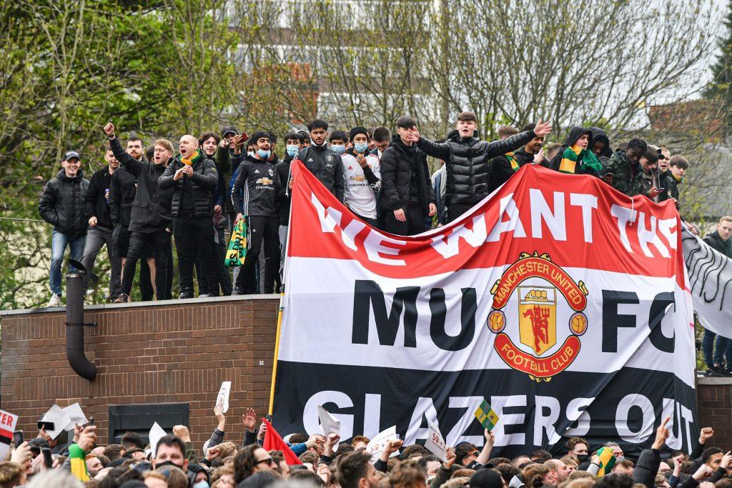Manchester United fans stage a roof top, as thousands gathered to protest outside Old Trafford today., Old Trafford, Manchester, UK – 02 May 2021