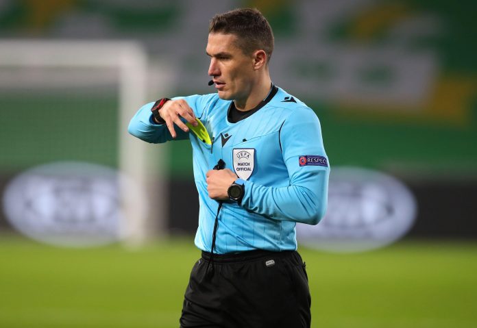 Referee Istvan Kovacs shows Sparta Prague's David Pavelka (centre) a yellow card for unsporting behaviour during the UEFA Europa League Group H match at Celtic Park, Celtic.